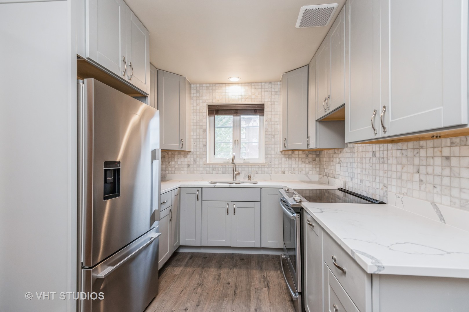 348 Ridge Avenue, Unit 2 Evanston, IL 60202 - Photo 7 of 16 a kitchen with a sink a refrigerator and cabinets