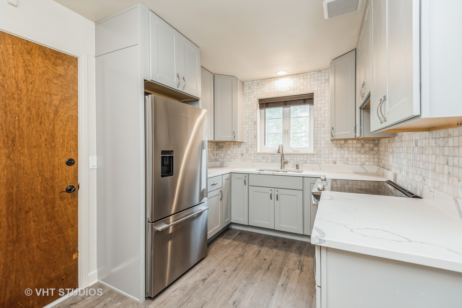 348 Ridge Avenue, Unit 2 Evanston, IL 60202 - Photo 8 of 16 a kitchen with a refrigerator sink and cabinets