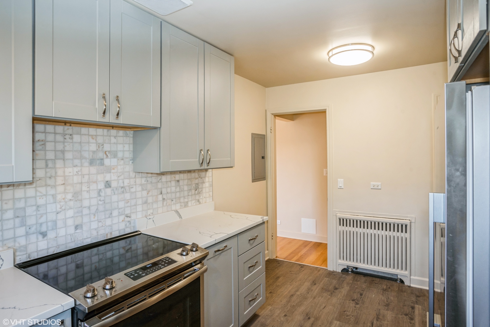 348 Ridge Avenue, Unit 2 Evanston, IL 60202 - Photo 9 of 16 a kitchen with a stove and white cabinets