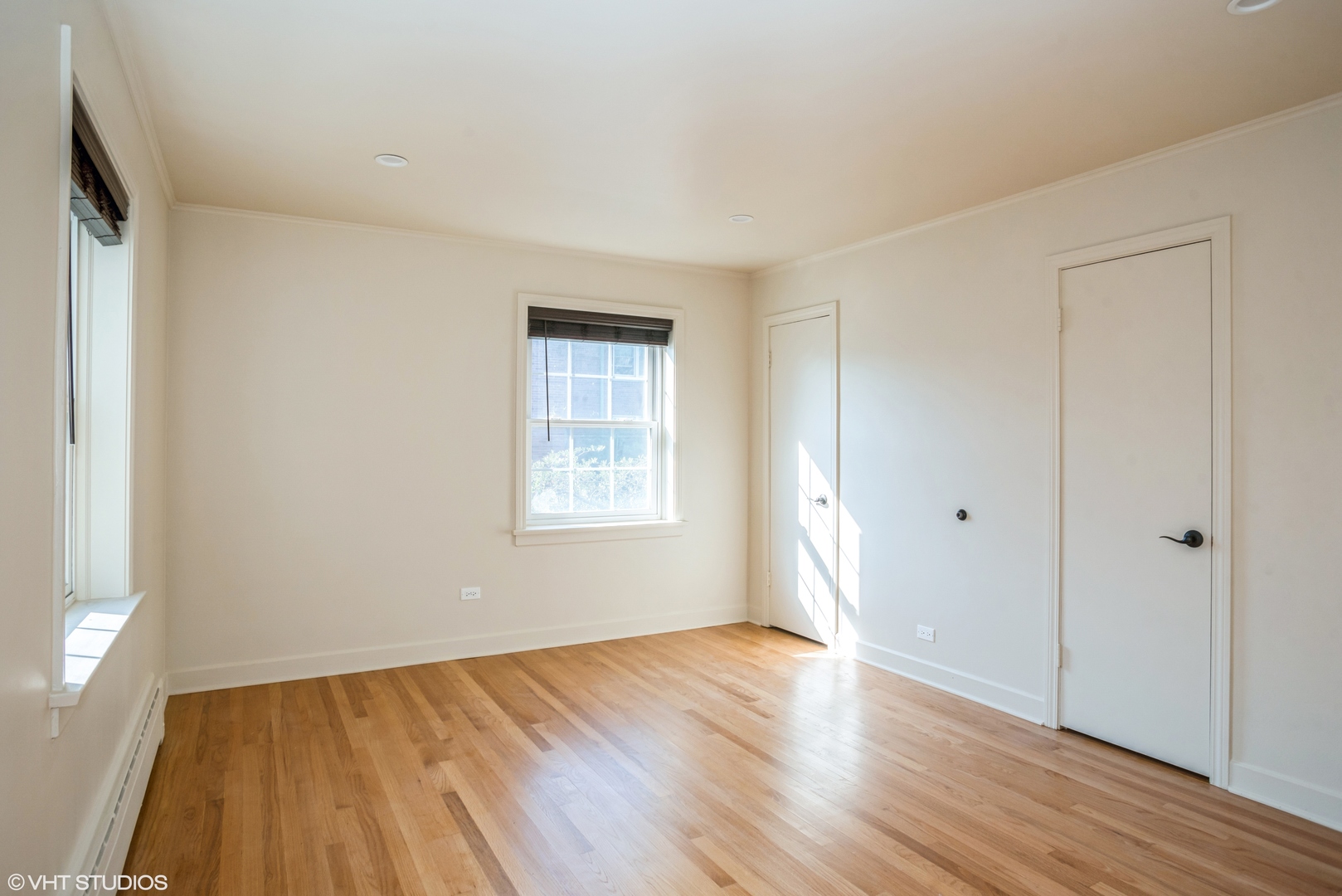 348 Ridge Avenue, Unit 2 Evanston, IL 60202 - Photo 10 of 16 a view of an empty room with wooden floor and a window
