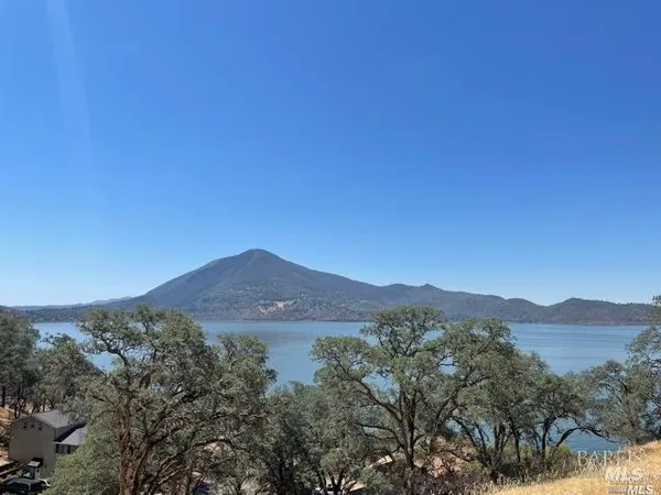 a view of a mountain range with lush green forest