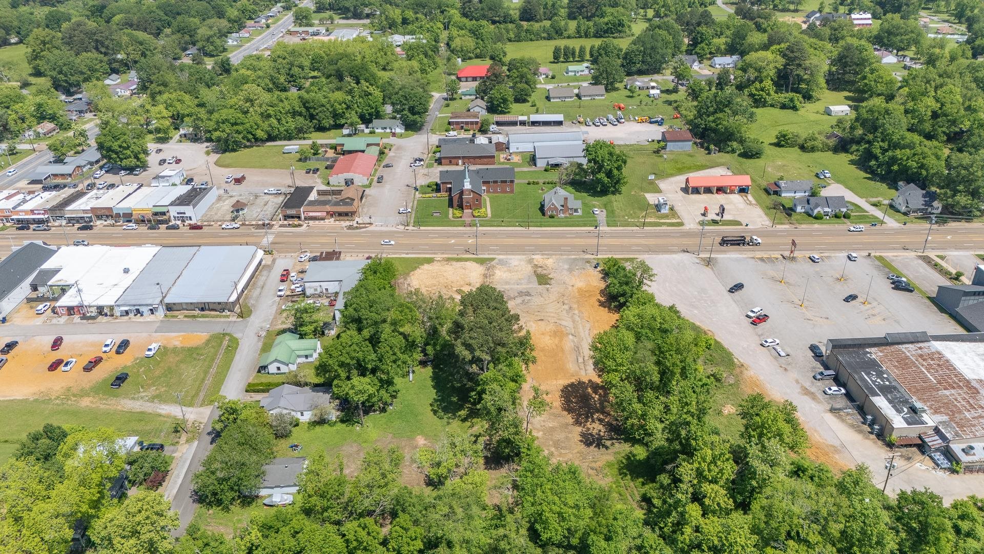 211 East Main Street Adamsville, TN 38310 - Photo 4 of 7 an aerial view of residential houses with outdoor space