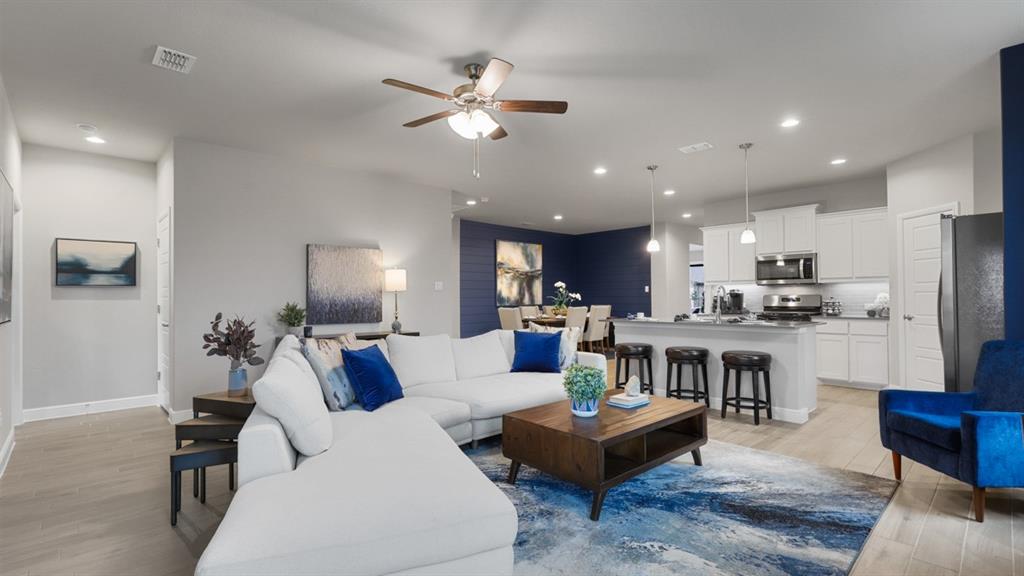 227 Windmill Drive Rhome, TX 76078 - Photo 12 of 34 a living room with furniture kitchen view and a chandelier