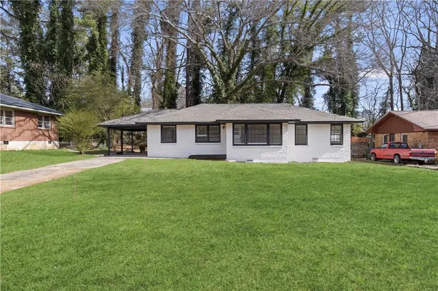 a front view of a house with a garden