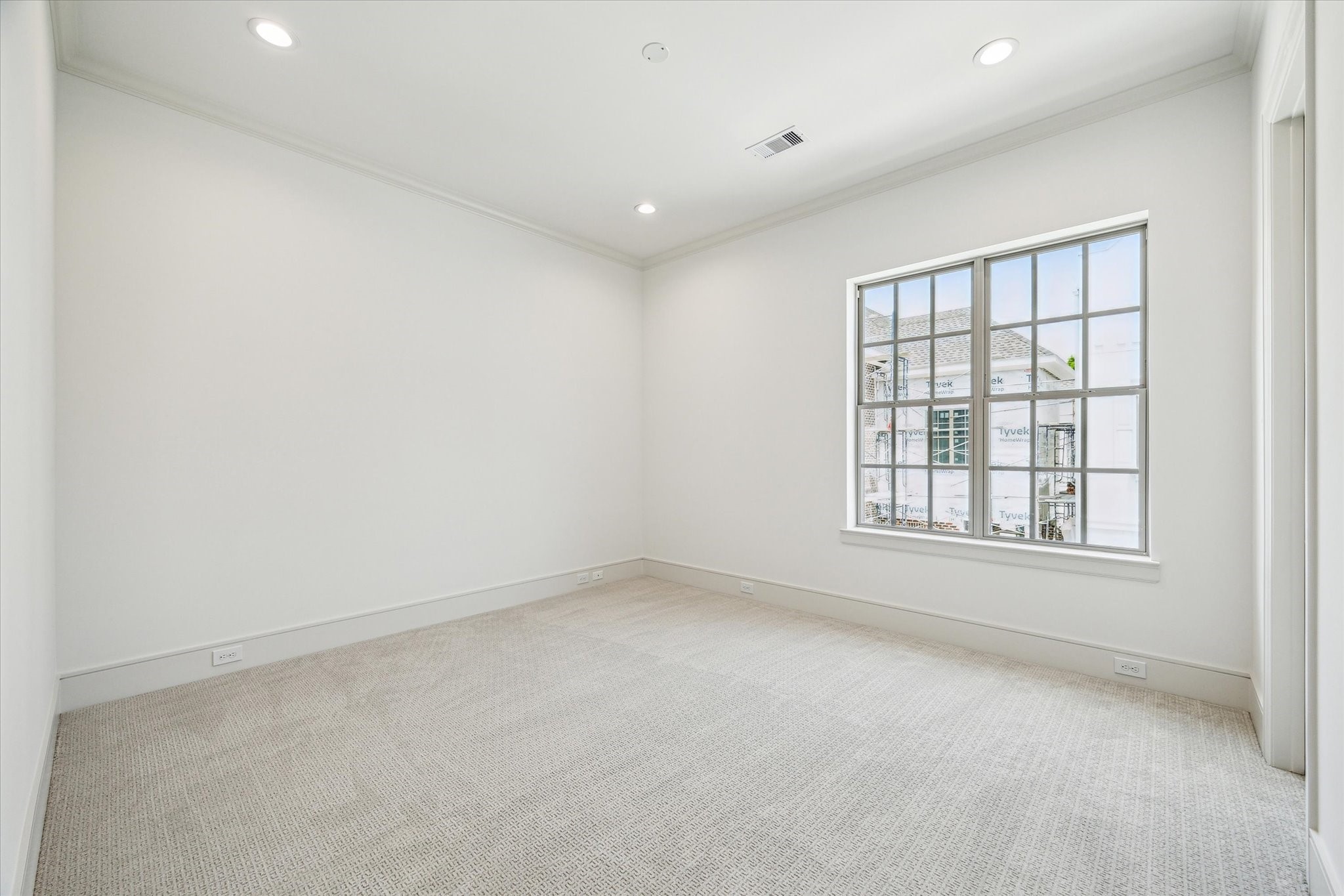 209 Sutton Row Place Houston, TX 77024 - Photo 12 of 23 Second-floor Secondary Bedroom with walk-in closet, a perfect space for an office or guest room.