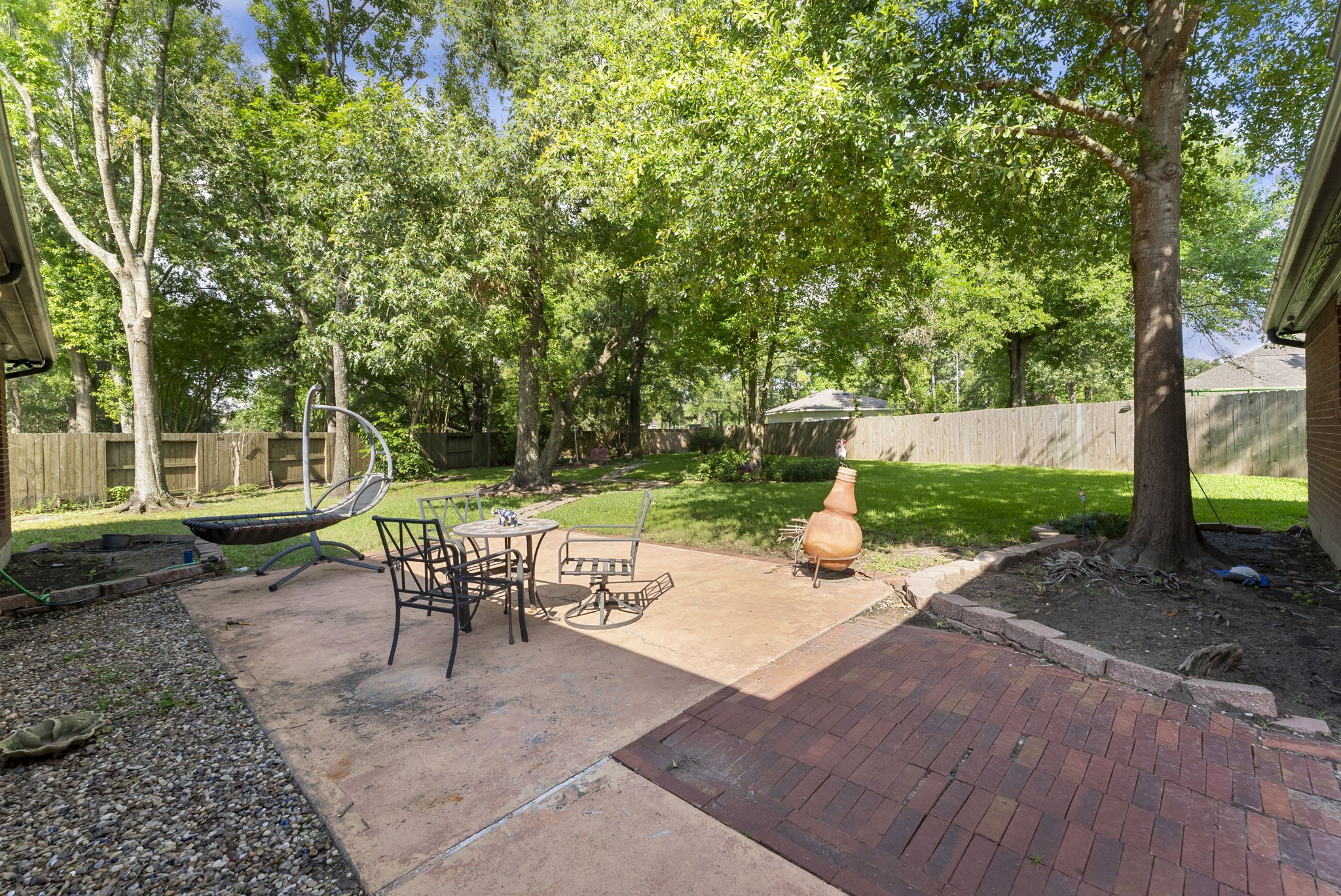12907 Ryaneagles Circle Houston, TX 77044 - Photo 41 of 48 a view of a patio with table and chairs potted plants and a large tree