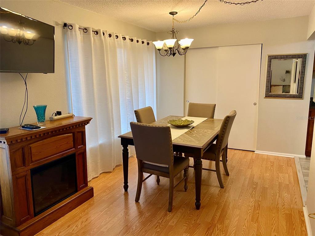 2360 Irish Lane, Unit 64 Clearwater, FL 33763 - Photo 18 of 45 a view of a dining room with furniture and wooden floor