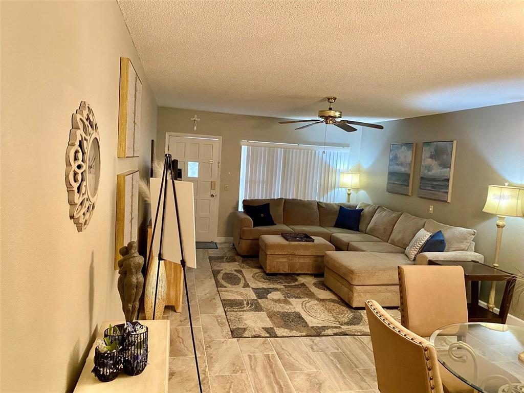 2360 Irish Lane, Unit 64 Clearwater, FL 33763 - Photo 5 of 45 a living room with furniture and a wooden floor