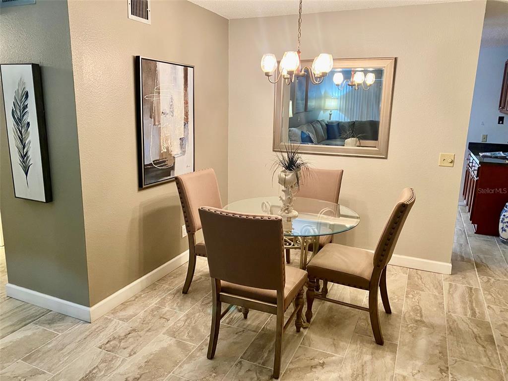2360 Irish Lane, Unit 64 Clearwater, FL 33763 - Photo 6 of 45 a dining room with furniture and window