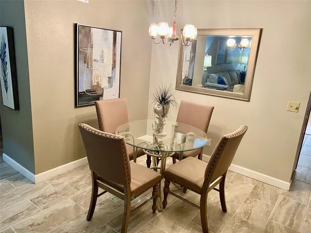 a large bed sitting in a bedroom next to a lamp