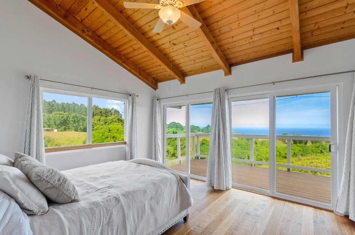 2100 Kaiwiki Road Hilo, HI 96720 - Photo 16 of 29 a bed sitting in a bedroom next to a window