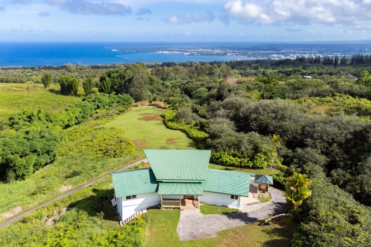 2100 Kaiwiki Road Hilo, HI 96720 - Photo 23 of 29 a view of a swimming pool with a yard and mountain view