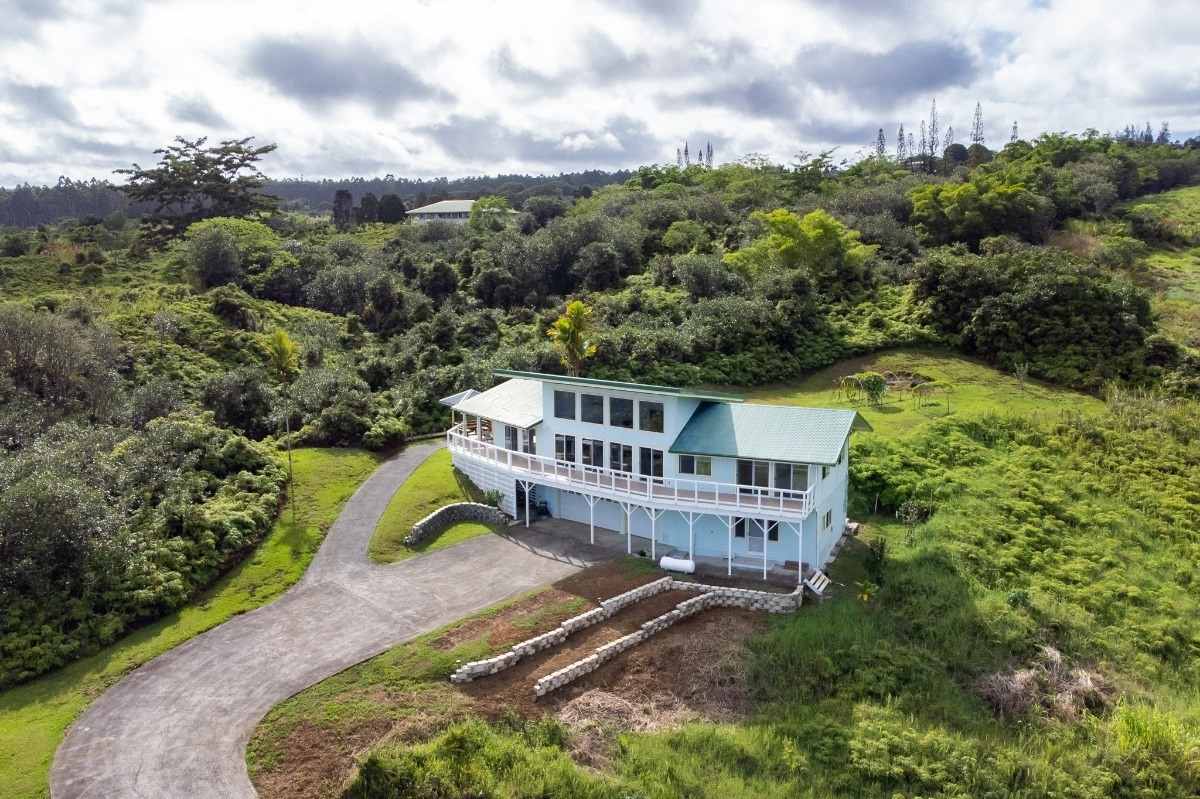 2100 Kaiwiki Road Hilo, HI 96720 - Photo 25 of 29 an aerial view of a house with a big yard and large trees