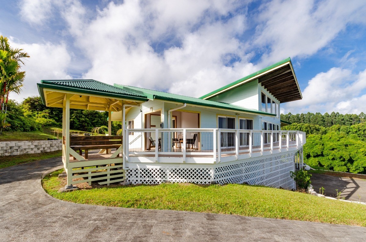 2100 Kaiwiki Road Hilo, HI 96720 - Photo 26 of 29 a front view of a house with swimming pool garden and patio