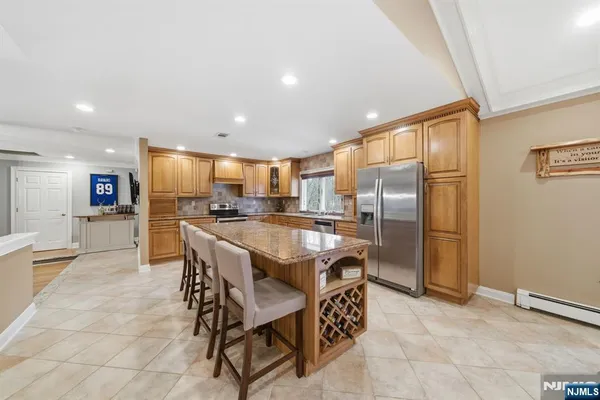 a kitchen with stainless steel appliances granite countertop a sink and cabinets