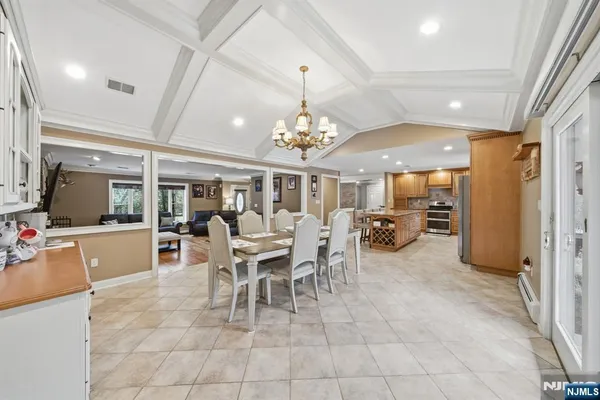 a dining room with furniture a chandelier and window