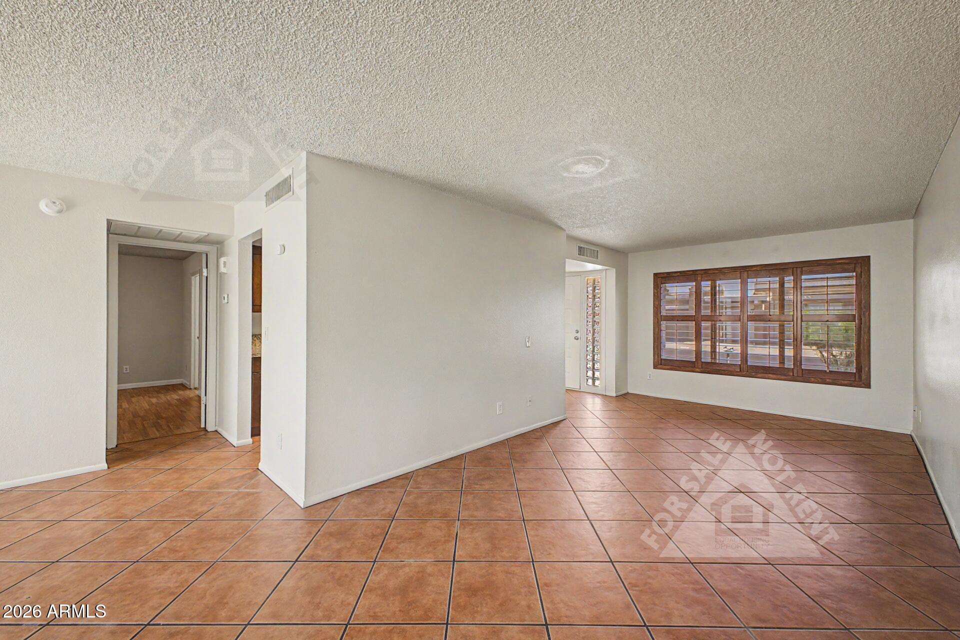 912 East Villa Rita Drive Phoenix, AZ 85022 - Photo 6 of 27 a view of an empty room with a window