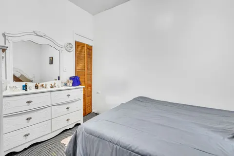 a bedroom with a bed and a dresser