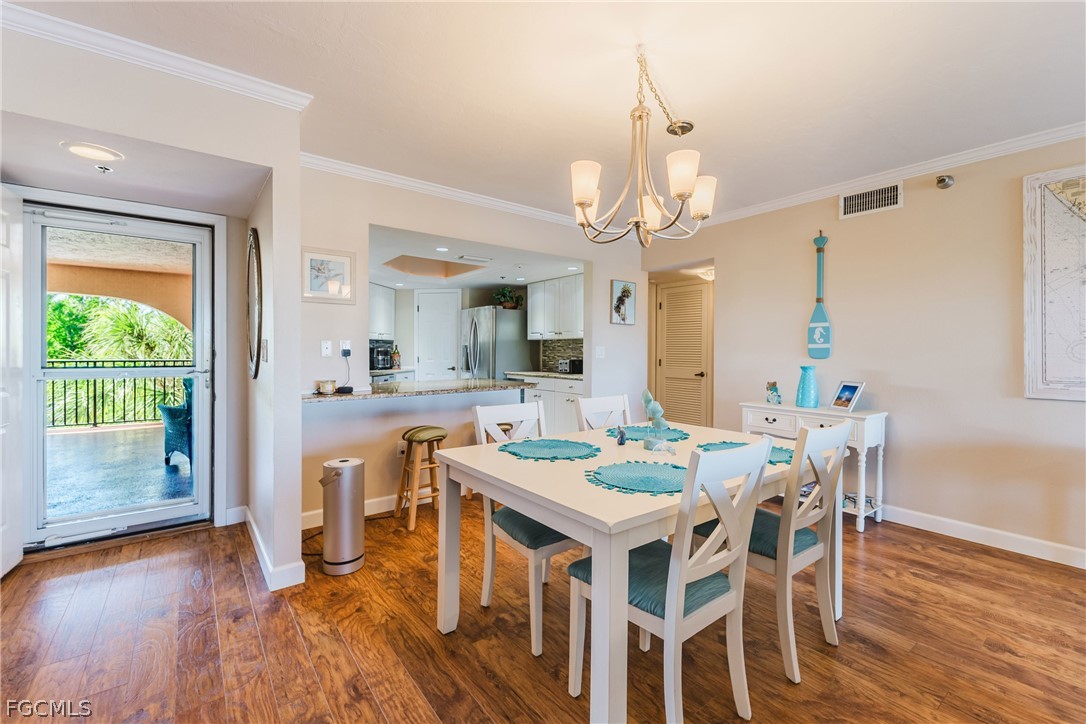 23465 Harbor View Road, Unit 734 Punta Gorda, FL 33980 - Photo 11 of 40 a view of a dining room with furniture window and wooden floor