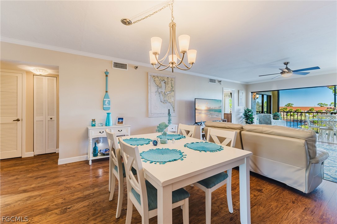 23465 Harbor View Road, Unit 734 Punta Gorda, FL 33980 - Photo 12 of 40 a view of a dining room with furniture and wooden floor