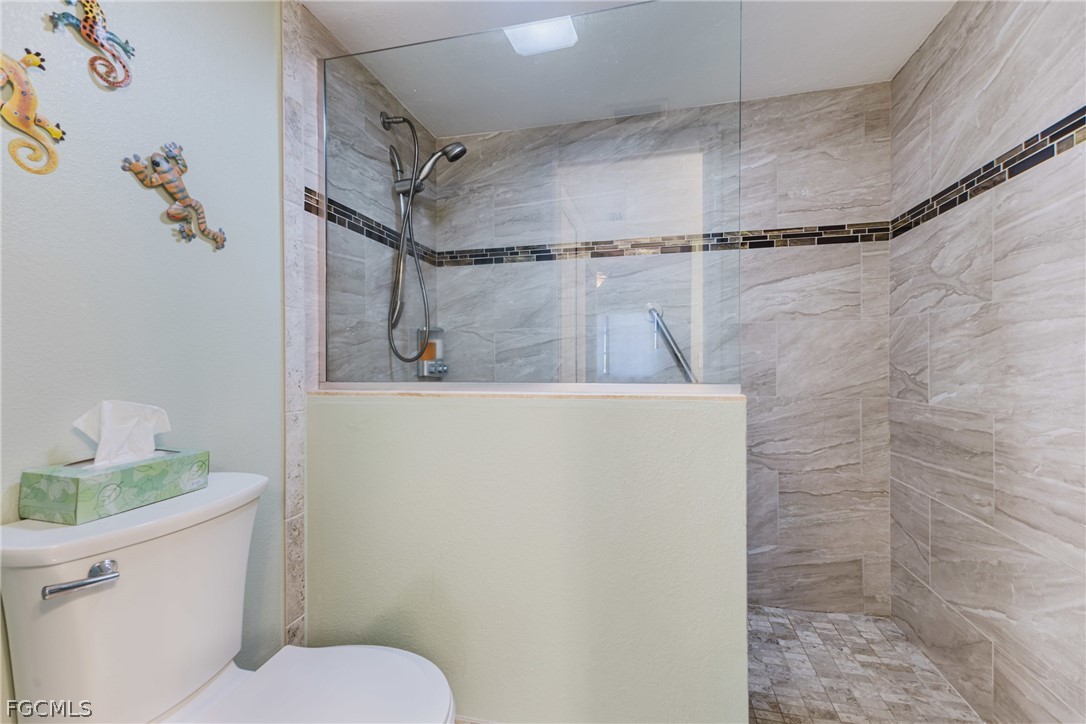 23465 Harbor View Road, Unit 734 Punta Gorda, FL 33980 - Photo 22 of 40 a bathroom with a shower a toilet and sink