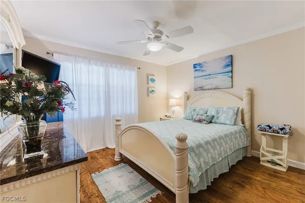 a bedroom with a bed potted plant and a window