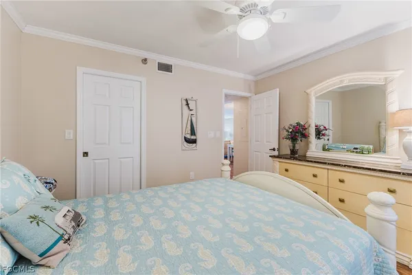 a spacious bedroom with a bed and a chandelier