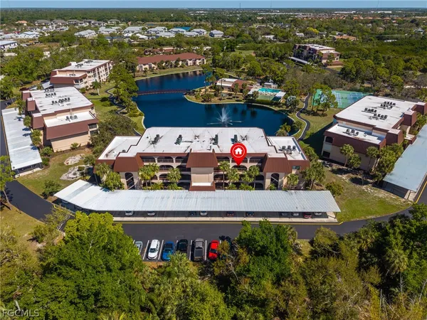 an aerial view of a house with a swimming pool lake view and mountain view