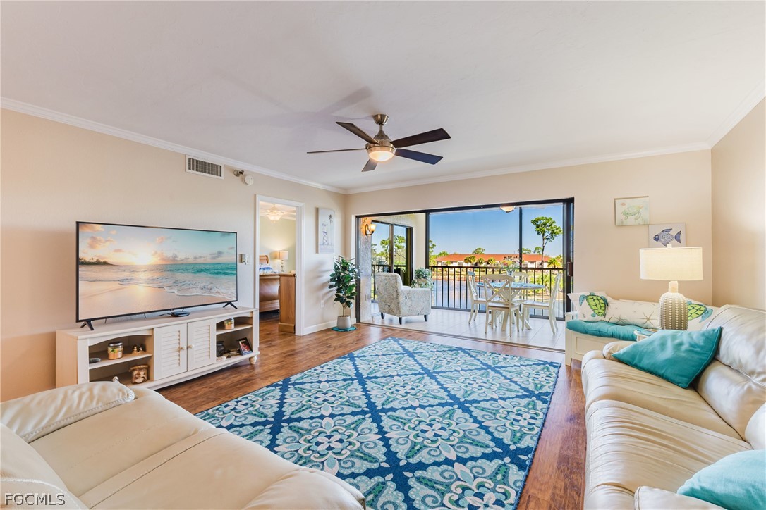 23465 Harbor View Road, Unit 734 Punta Gorda, FL 33980 - Photo 5 of 40 a living room with furniture a flat screen tv and a table