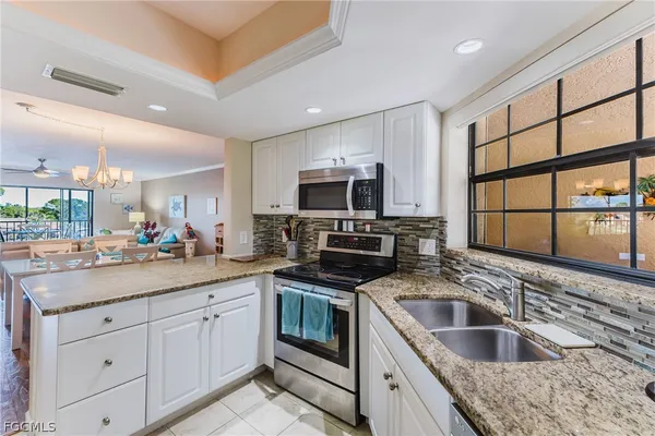 a kitchen with a sink stove and microwave