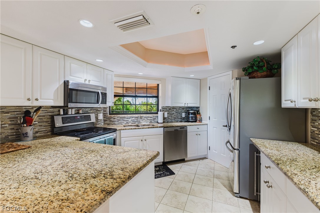 23465 Harbor View Road, Unit 734 Punta Gorda, FL 33980 - Photo 10 of 40 a kitchen with stainless steel appliances granite countertop a stove oven and a refrigerator