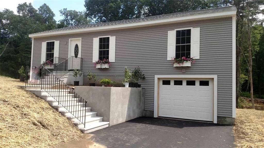 6 Harrisville Road Putnam, CT 06260 - Photo 1 of 1 a front view of a house with a garage