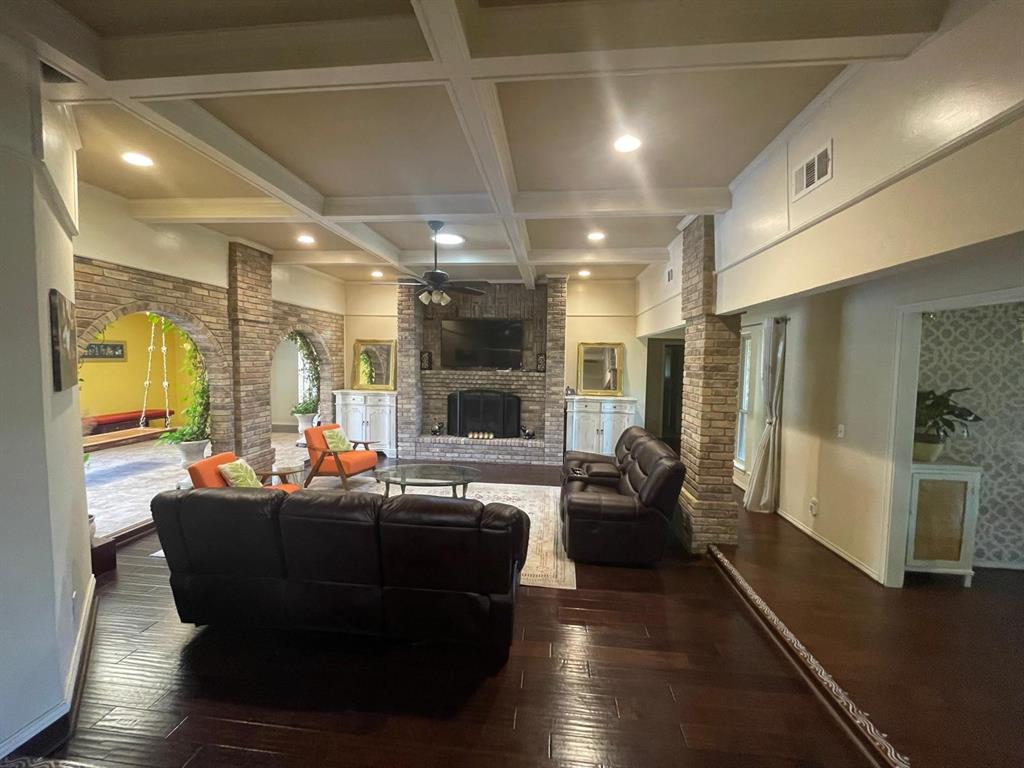 3612 Cross Bend Road Plano, TX 75023 - Photo 7 of 38 Living room with a fireplace, coffered ceiling, dark hardwood / wood-style flooring, and beamed ceiling