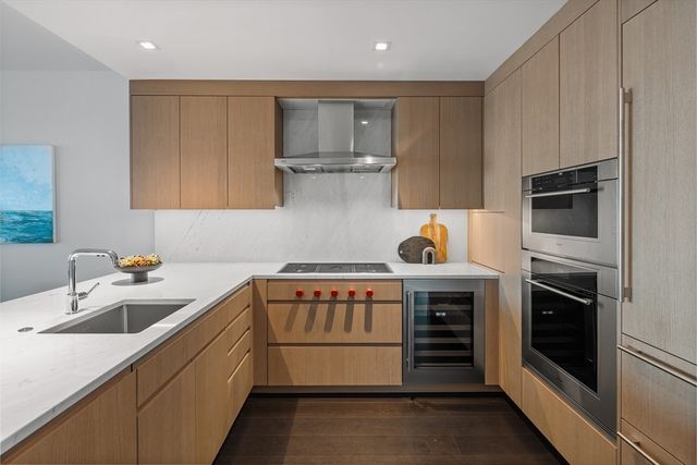 a kitchen that has a sink and a stove in it