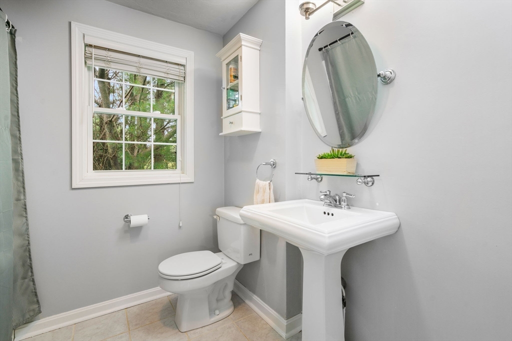 995 Trapelo Road, Unit 1 Waltham, MA 02452 - Photo 12 of 19 a bathroom with a toilet sink and mirror