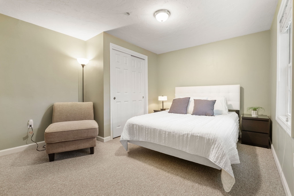 995 Trapelo Road, Unit 1 Waltham, MA 02452 - Photo 13 of 19 a bedroom with two beds and lamp