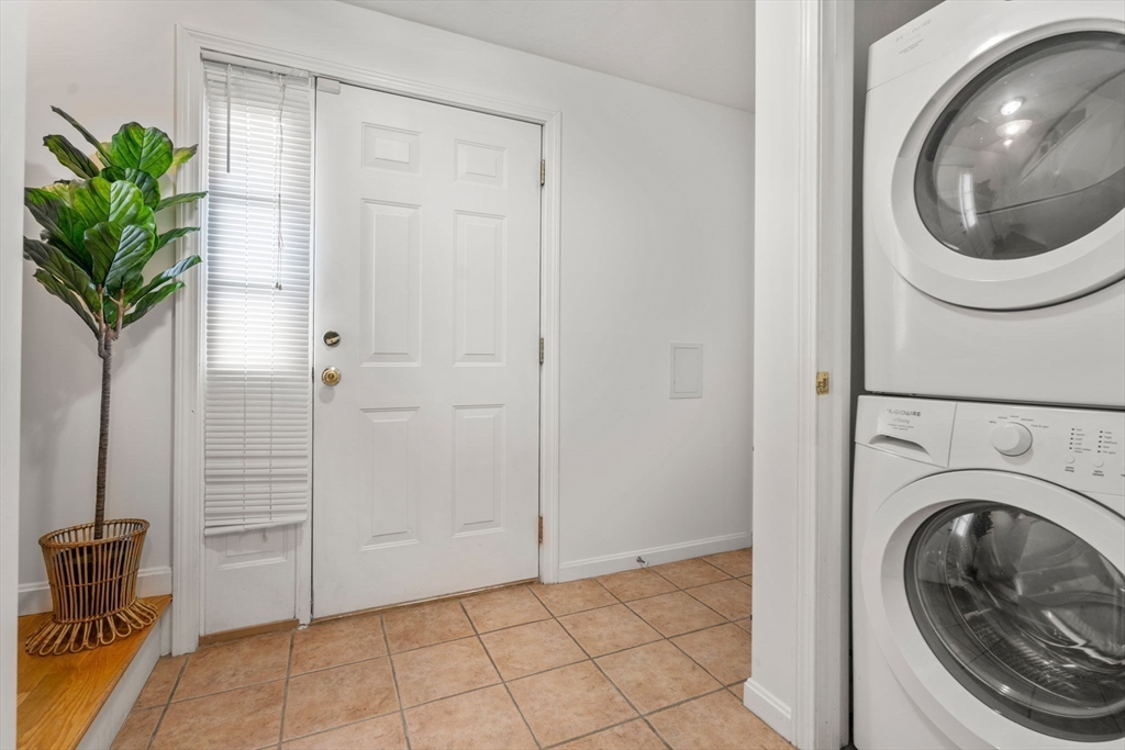 995 Trapelo Road, Unit 1 Waltham, MA 02452 - Photo 16 of 19 a view of a hallway with washer and dryer
