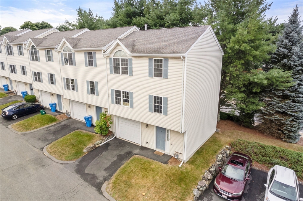 995 Trapelo Road, Unit 1 Waltham, MA 02452 - Photo 17 of 19 a view of a white house with a yard and sitting area