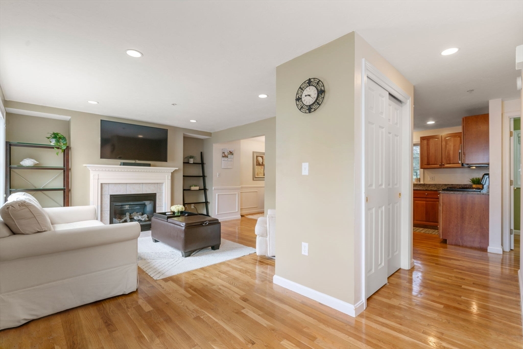 995 Trapelo Road, Unit 1 Waltham, MA 02452 - Photo 2 of 19 a living room with furniture a fireplace and a flat screen tv