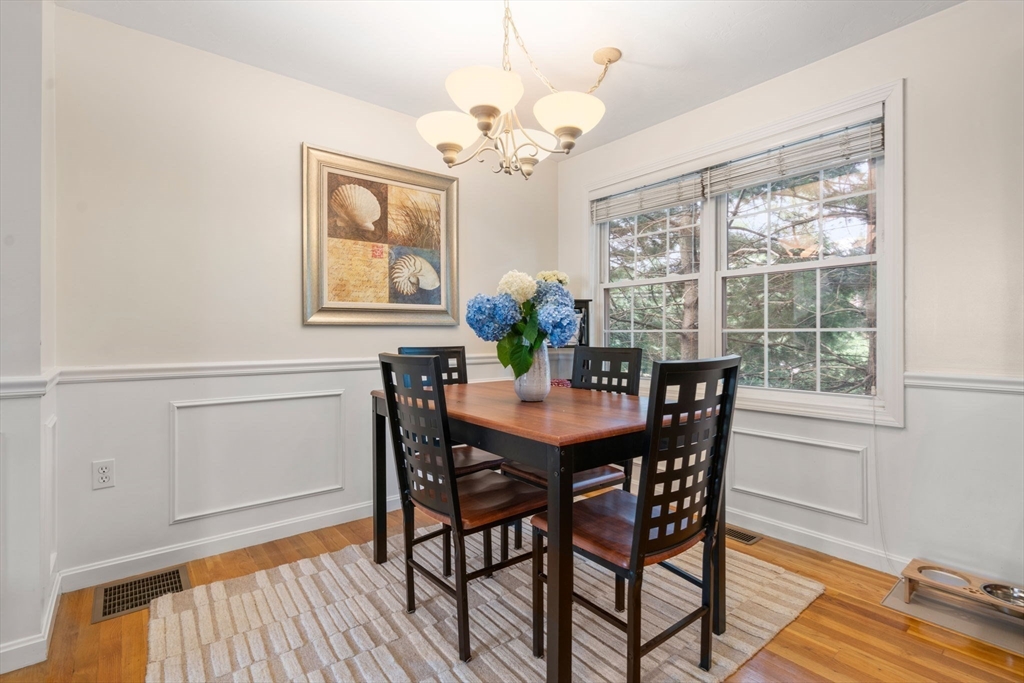 995 Trapelo Road, Unit 1 Waltham, MA 02452 - Photo 8 of 19 a view of a dining room with furniture a chandelier and wooden floor