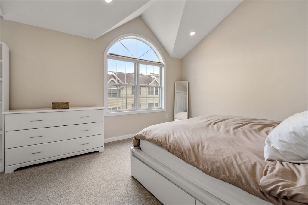 995 Trapelo Road, Unit 1 Waltham, MA 02452 - Photo 10 of 19 a bedroom with a bed and a window