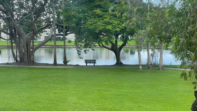 a view of a white house with a yard