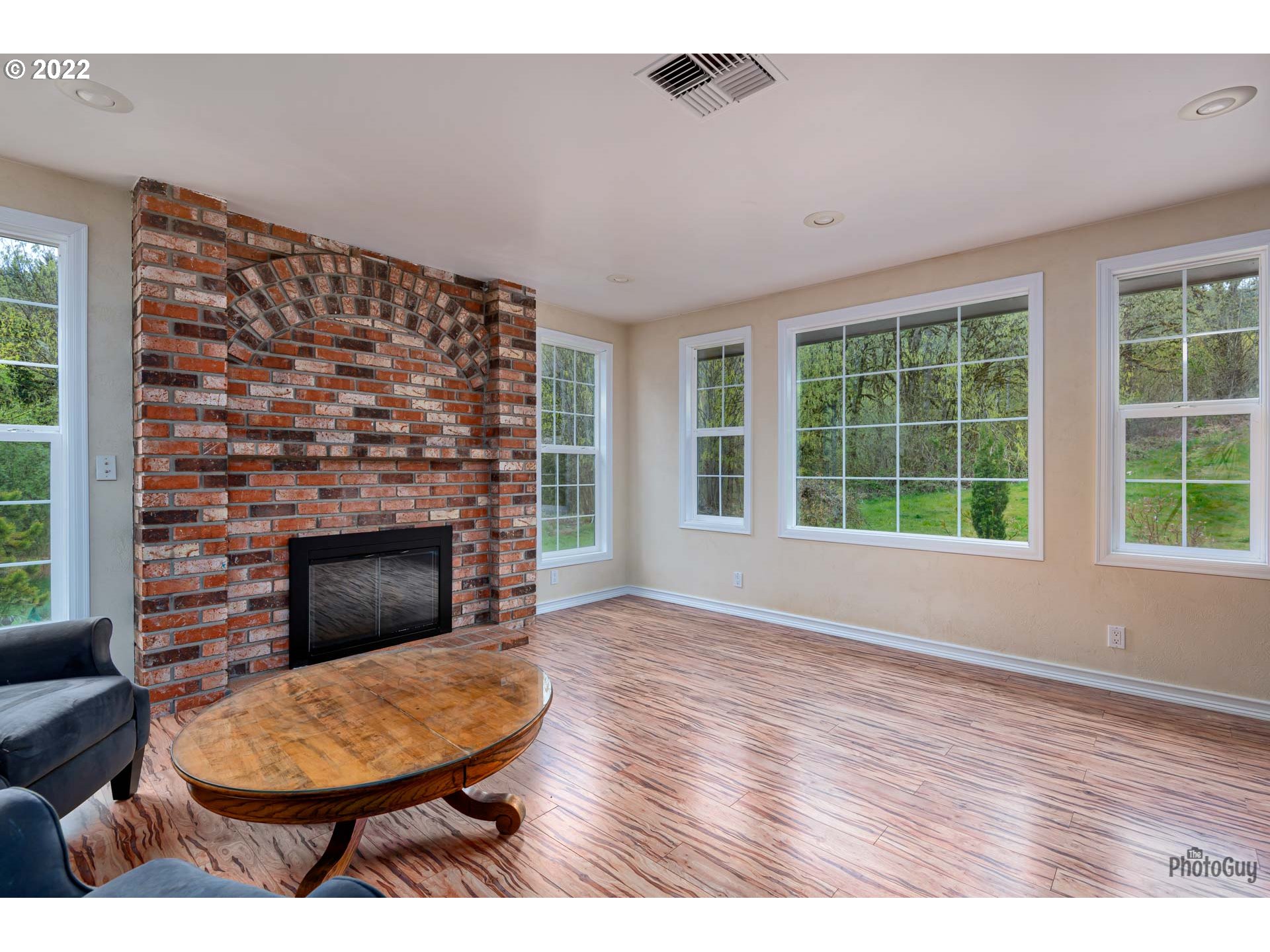 87533 Cedar Flat Road Springfield, OR 97478 - Photo 6 of 32 a living room with furniture a window and a fireplace
