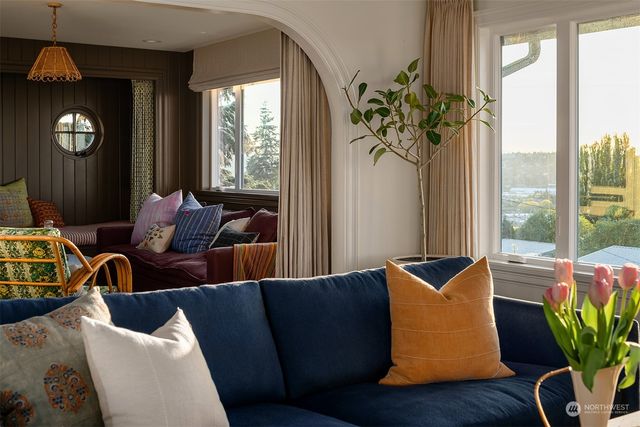 a living room with furniture and a potted plant