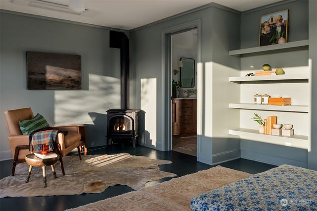 a bedroom with furniture and a fireplace