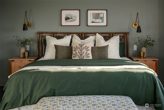 a bedroom with a bed and painting on the wall