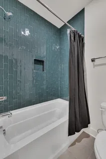 a bathroom with a shower and a bathtub