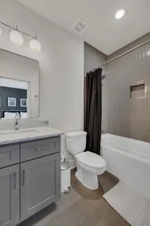 a bathroom with a toilet a sink and bathtub