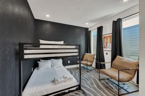 a bedroom with furniture and wooden floor