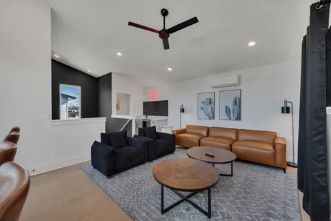 a living room with furniture a ceiling fan and a window